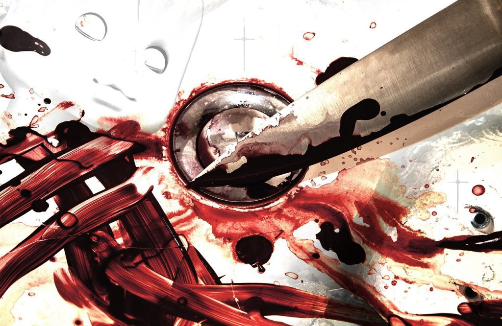 butcher knife in a sink with blood al over it