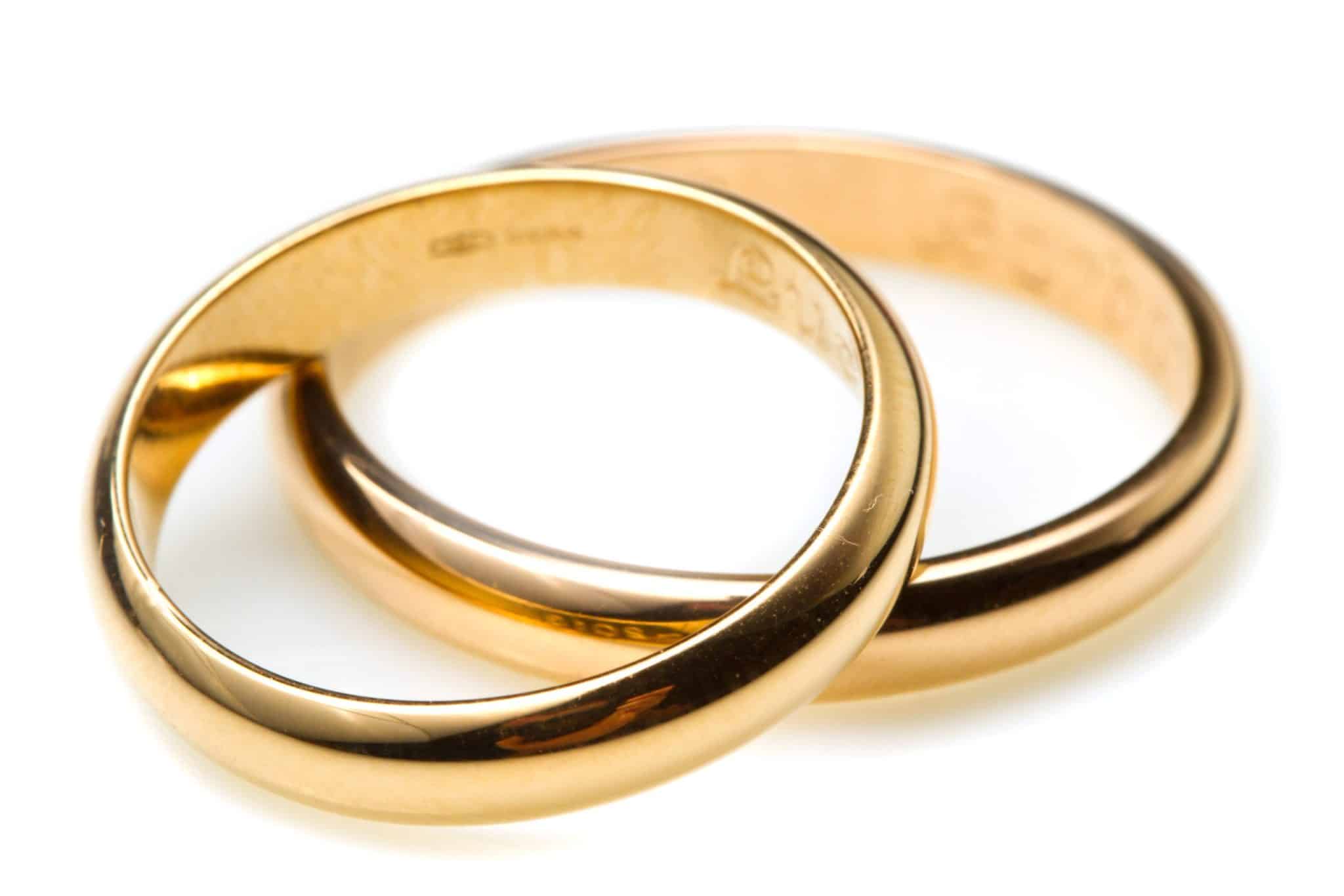 Divorce lawyer in Chicago. Two wedding rings one on top of the other on white background