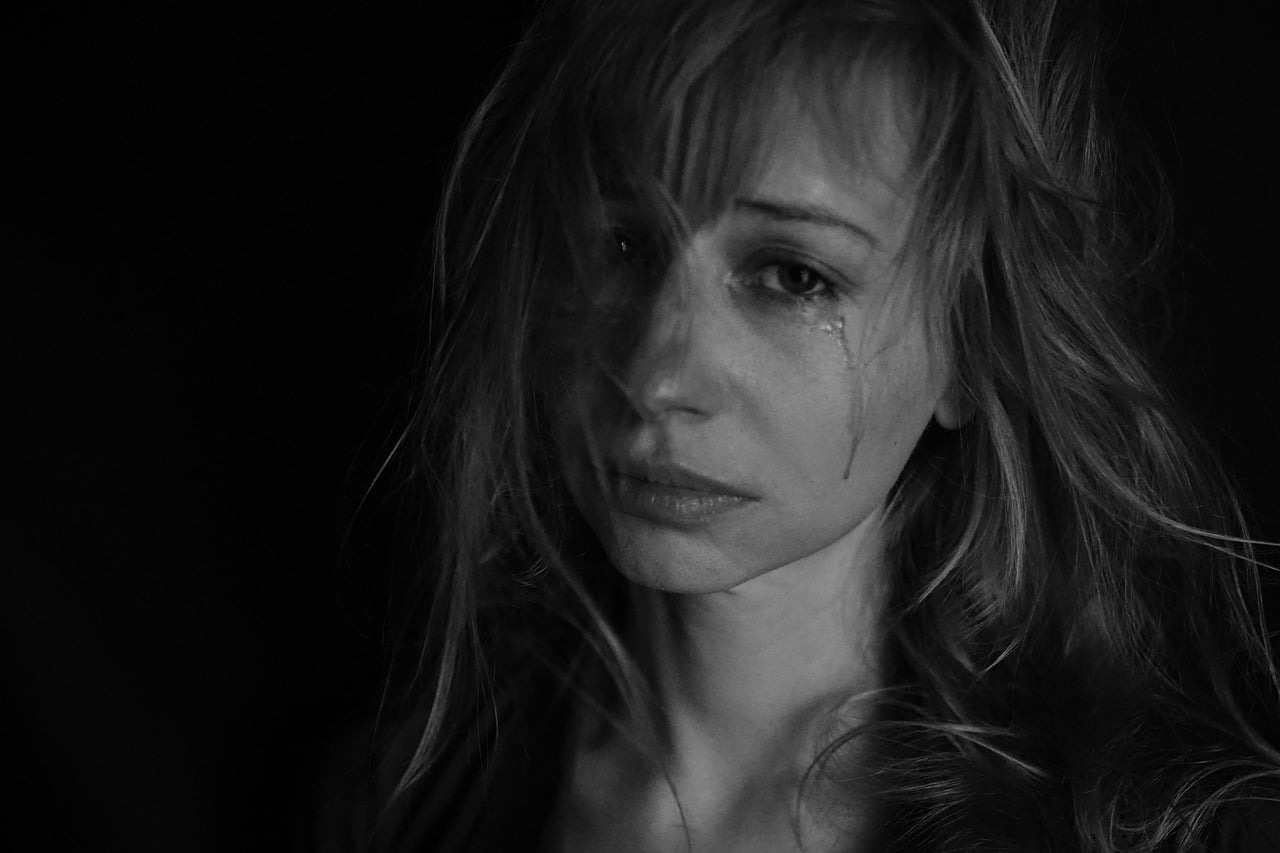 black & white picture of a young woman crying