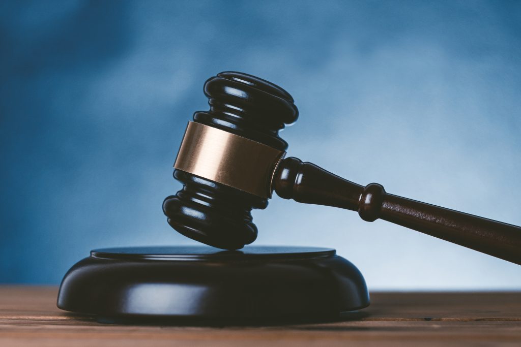 judge's gavel against blue background