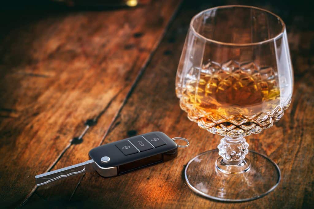 brandy sniffter and car key on the table