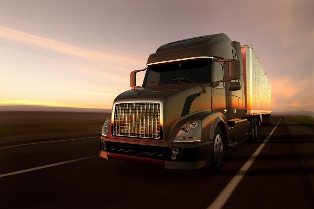 truck driving at sunset